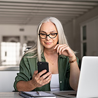 Mature woman looking at smart phone
