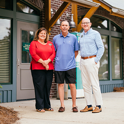 Photo of mortgage customer with CFB mortgage lender and processor.