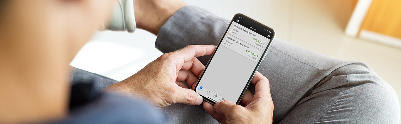 Person using cell phone with mobile banking app.