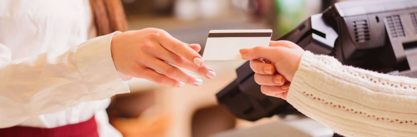 Cropped image of customer paying with credit card at register